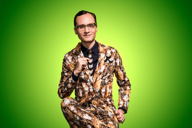 Joey Clift wears a cat suit while smiling for the camera 